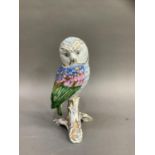 A Herend style china figure of an owl perched on a branch by Vista Alegre, Portugal, painted by hand