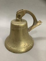 A ship's brass bell, with hanging bracket, 20cm high