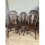 A set of six wheel back dining chairs comprising two carvers and four singles