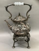 A Victorian Britannia metal spirit kettle and stand of baluster form with raised foliate decoration,