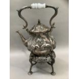 A Victorian Britannia metal spirit kettle and stand of baluster form with raised foliate decoration,