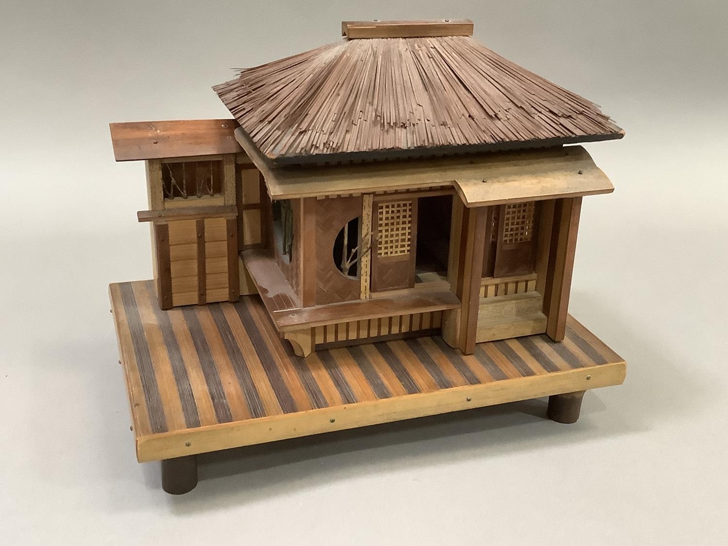 Model of a Japanese house raised on a platform and with bamboo feet. 23.5cm wide x 15.5cm deep x