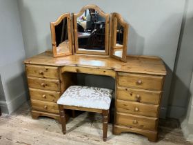 A modern pine dressing table with two banks of four drawers, upholstered stool and dressing table