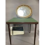 A card table with fold out legs, gilt pierced oval wall mirror and another mirror with bevelled
