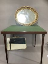 A card table with fold out legs, gilt pierced oval wall mirror and another mirror with bevelled