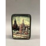 A modern Russian lacquered hinged box, the lid hand painted with a winters scene of St Basil's