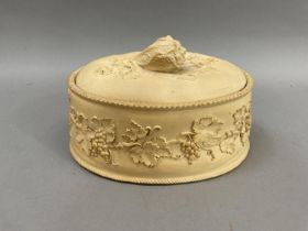 A 19th century Wedgewood caneware game dish of oval outline having a cauliflower finial, a grapevine