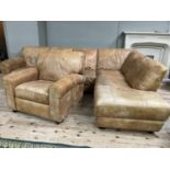 An 'L' shaped corner sofa in tan leather with matching reclining armchair, purchased from Barker and