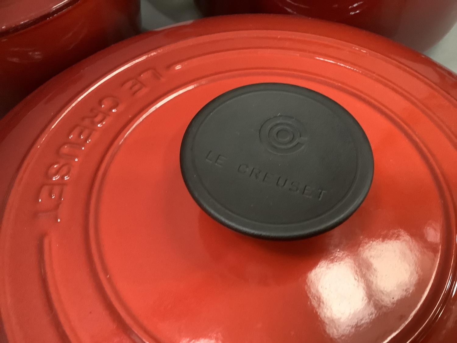 A set of three Le Creuset two handled casseroles in flame red, with lids, as new, 19cm, 22.5cm and a - Image 2 of 2