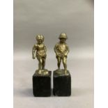 After Perot, a pair of 19th century brass sculptures of a boy and girl paddling raised on black