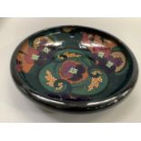 A twentieth century Art Deco glass bowl, the interior painted with purple flowers with foliage on an