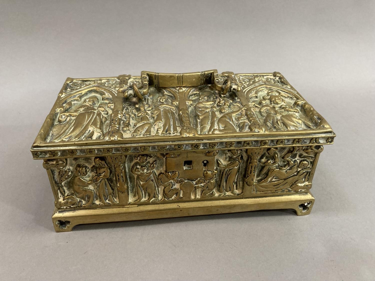 A Victorian brass casket cask with figures of saints within trefoil arches and similar to each