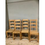 A set of four hardwood ladder back chairs