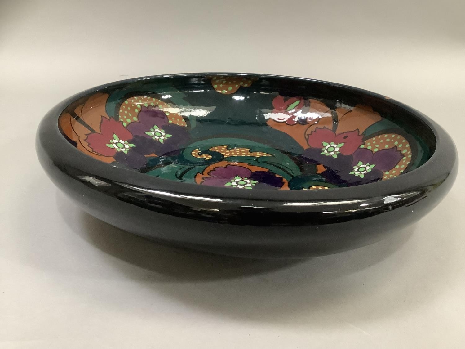 A twentieth century Art Deco glass bowl, the interior painted with purple flowers with foliage on an - Image 2 of 3