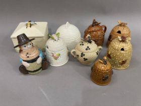 A collection of honey pots in the form of Skeps and other designs including Crown Devon Wedgwood and