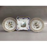 A pair of 19th century Meissen porcelain plates, polychrome painted with birds perched on leafy