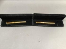 Two gilt metal Dunhill fountain pens, yellow metal nibs (tests as 14ct),in cases