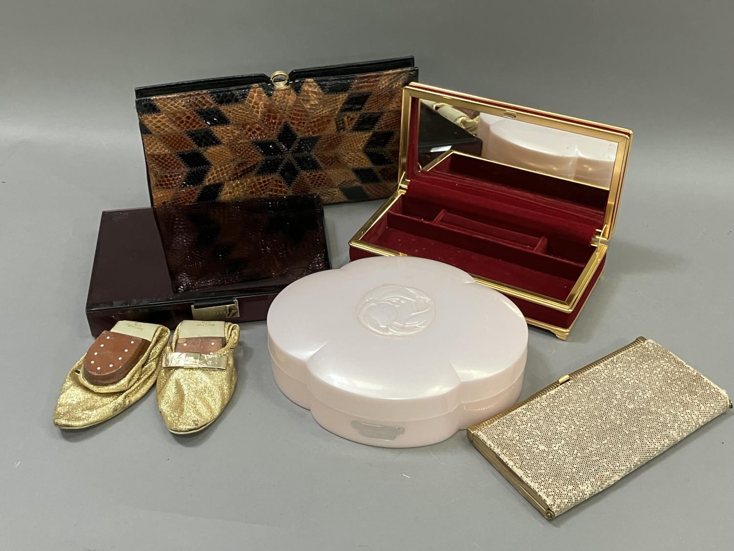 A snakes skin handbag in original packaging, a 1960's evening purse, a pair of gold lurex evening