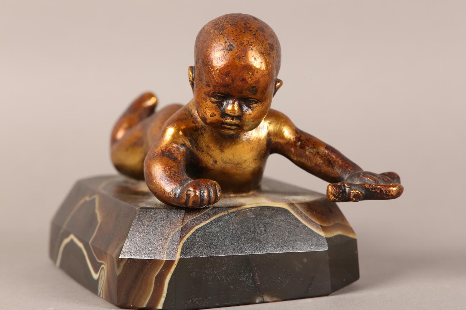 A gilded bronze figure of an infant lying on it's stomach, on an agate base, 14.5cm long x 9.5cm - Image 3 of 4