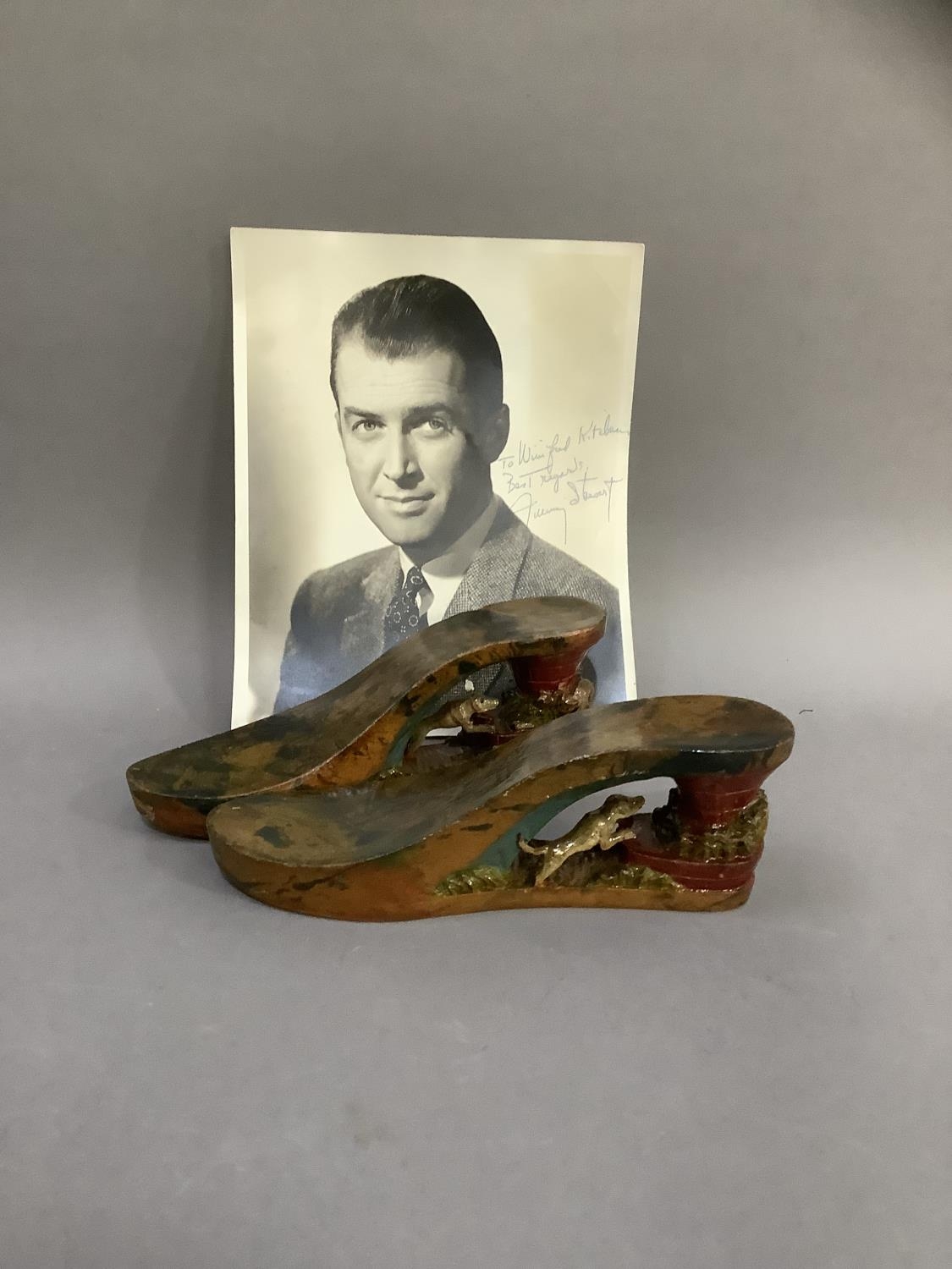 A pair of WWII painted wooden sandles and a photograph of James Stewart with inscription 'To