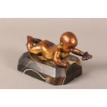 A gilded bronze figure of an infant lying on it's stomach, on an agate base, 14.5cm long x 9.5cm