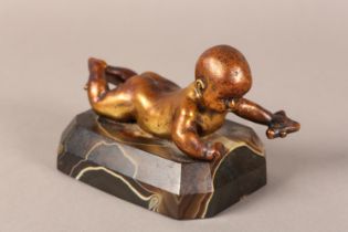 A gilded bronze figure of an infant lying on it's stomach, on an agate base, 14.5cm long x 9.5cm