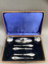 A George V seven piece silver manicure set, Birmingham 1919, all of indented outline and in original