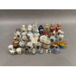 A collection of miniature china and pottery including vases, crested chinaware, cups, figures, etc