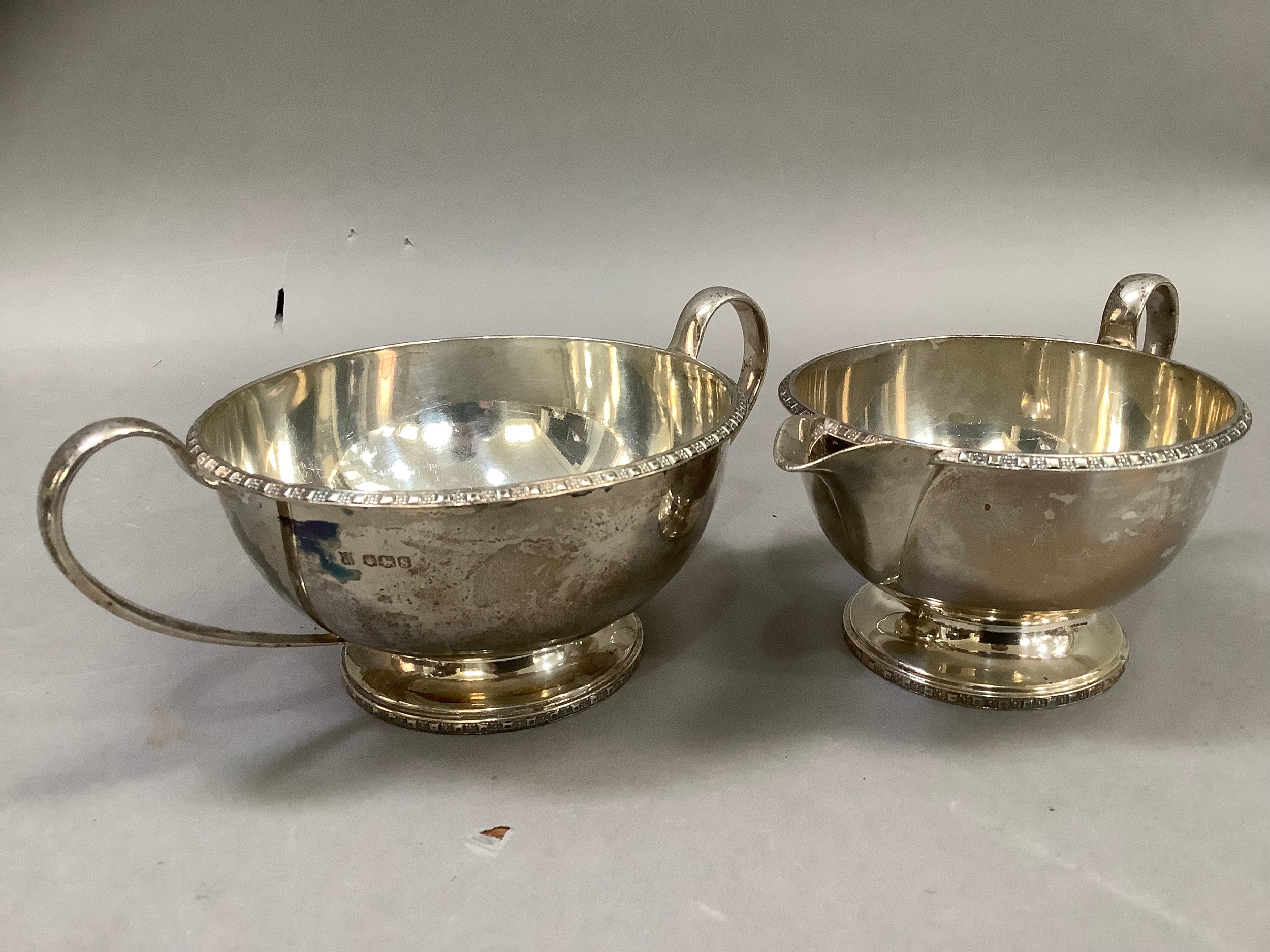 A Queen Elizabeth II silver cream jug, sugar bowl, Sheffield 1960 for Cooper Brothers and Sons, of