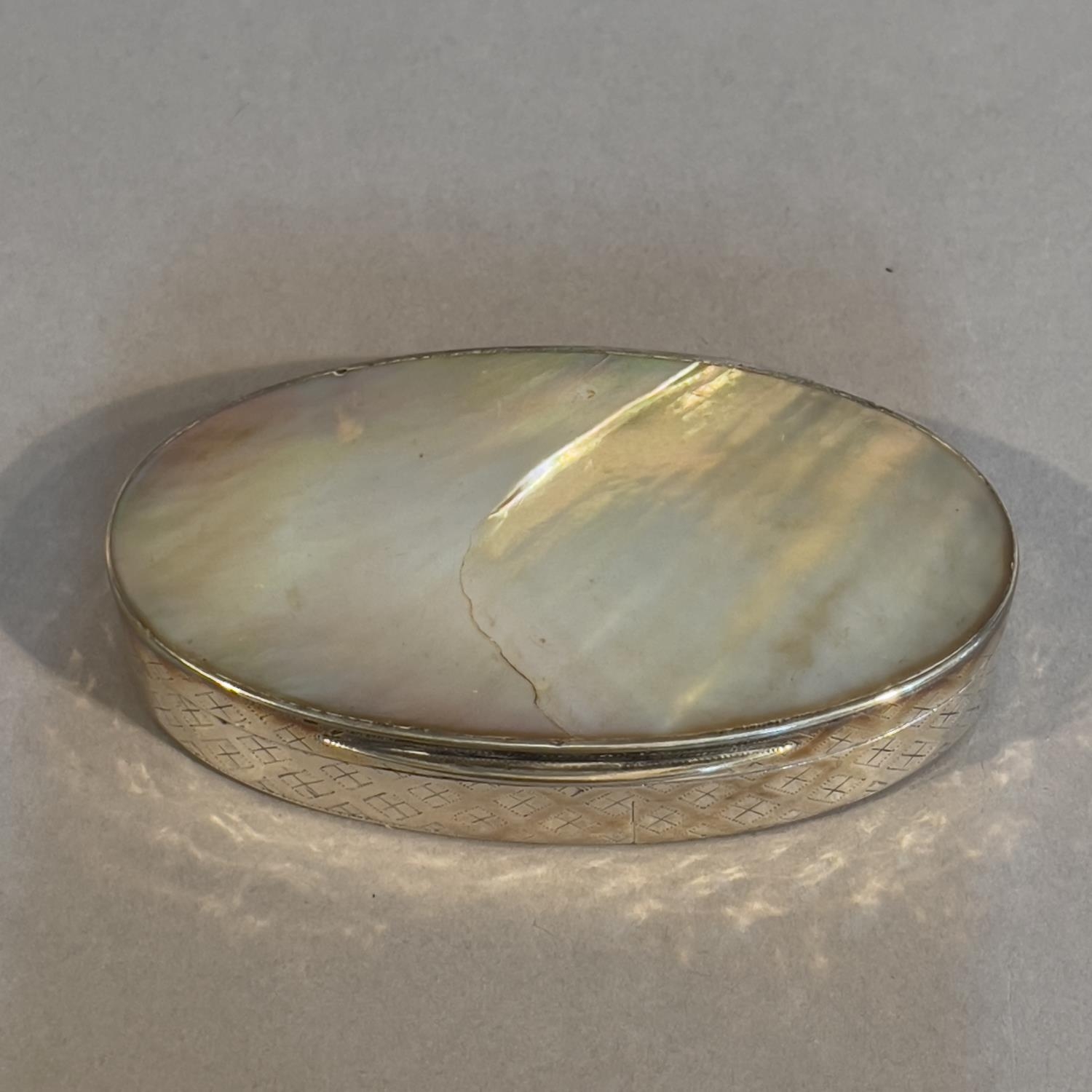 A late 19th century silver and mother of pearl; snuff box, oval, the sides embossed with a trellis