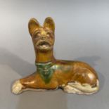 A Tang-style Sancai glazed pottery figure of a recumbent dog 18cm wide x 14cm high (Shipping
