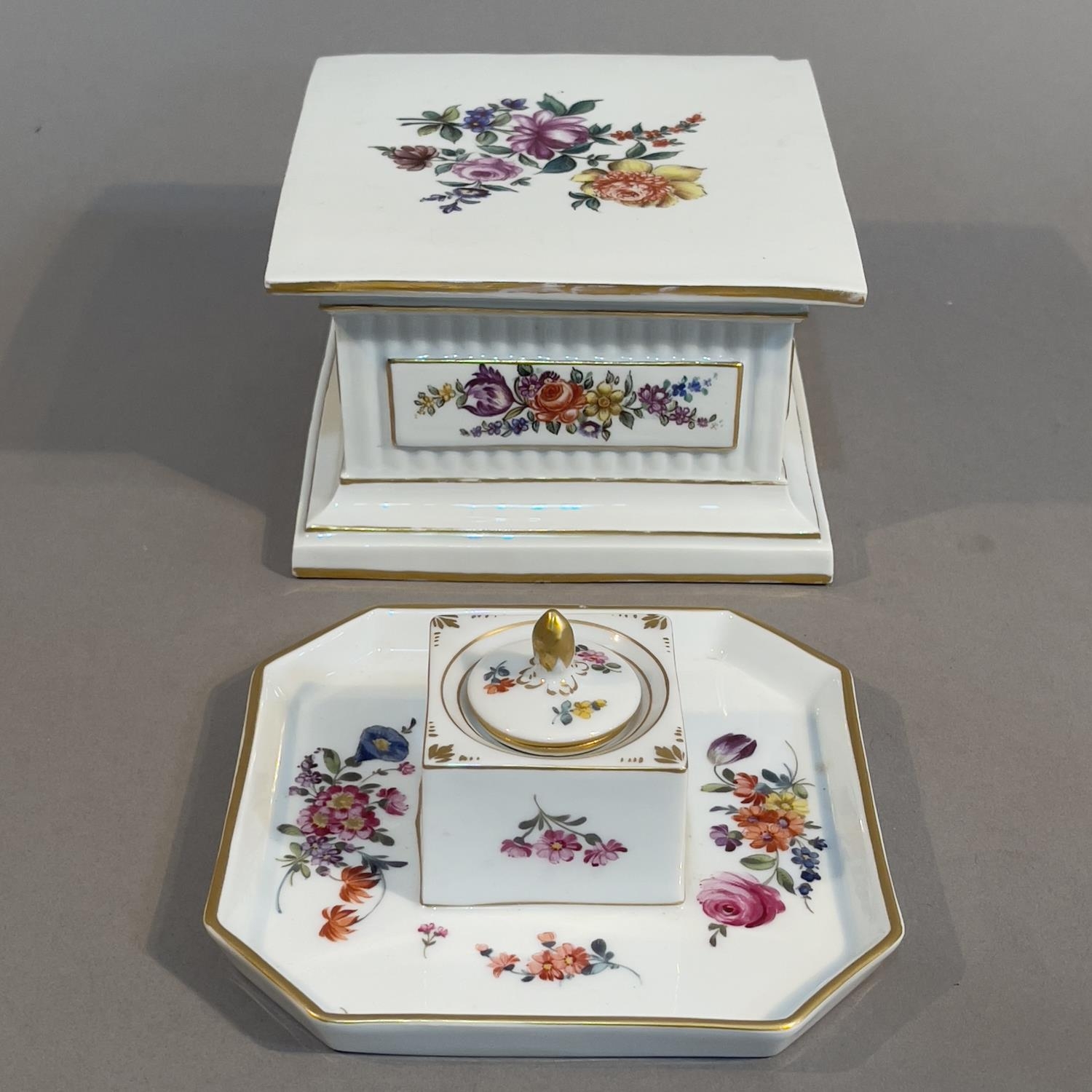 A 19th century Furstenberg porcelain stand of square outline, polychrome painted with a spray of