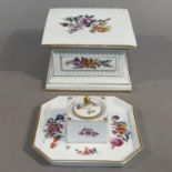 A 19th century Furstenberg porcelain stand of square outline, polychrome painted with a spray of