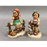 Two Hummel figures, girl on a fence with basket beside her and boy with goat and kid, 12cm and