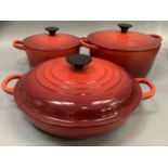 A set of three Le Creuset two handled casseroles in flame red, with lids, as new, 19cm, 22.5cm and a