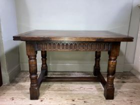 A Titchmarsh and Goodwin oak drawer leaf extending dining table on turned legs joined by an 'H'