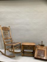 An oak rocking chair with bobbin supports and carved crest together with an oak stool with carved