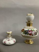 A continental scent bottle with bulbous body and globe stopper, hand painted with sprays of flower