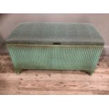 A Lloyd Loom green blanket box with upholstered seat, together with an ebonised folding table