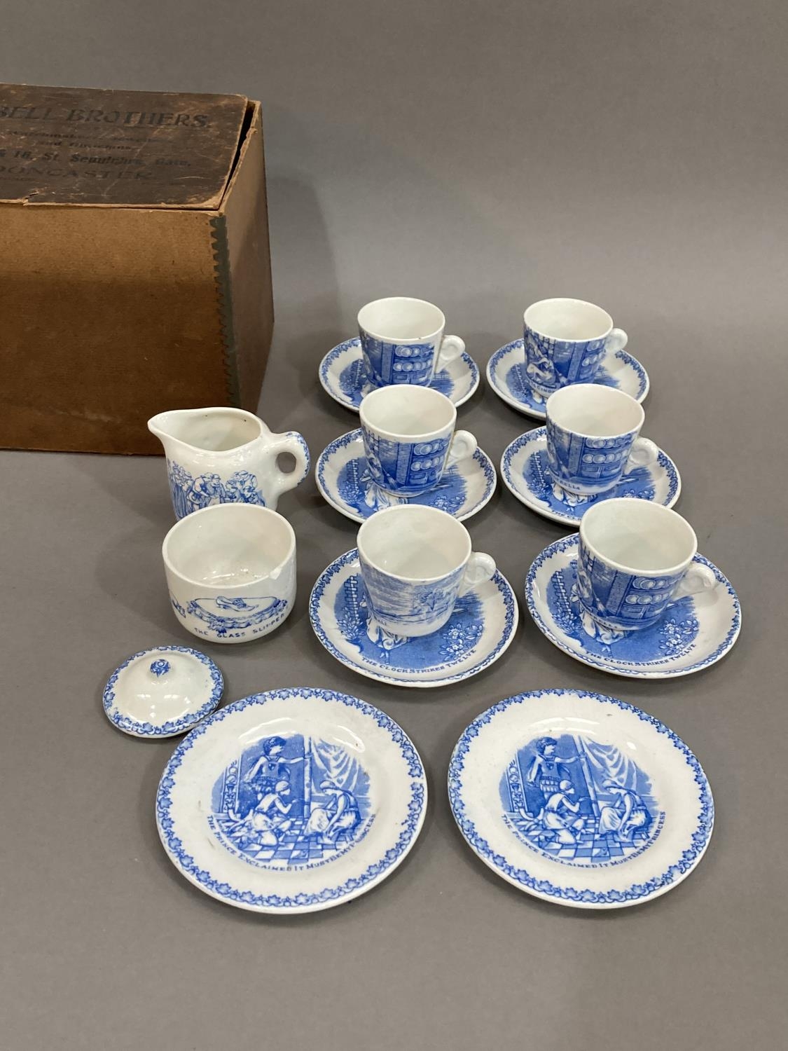 A 19th century blue and white miniature dolls tea set painted with scenes from Cinderella,