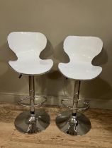 A pair of chrome and white perspex bar stools