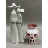 A large Lladro figure group of two nuns, 32cm high together with a Bohemian white glass, ruby