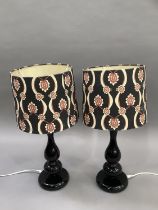 A pair of black perspex moulded retro style lamps having black, cream and red shades, 35cm high
