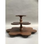 A mahogany three tier stand with revolving base