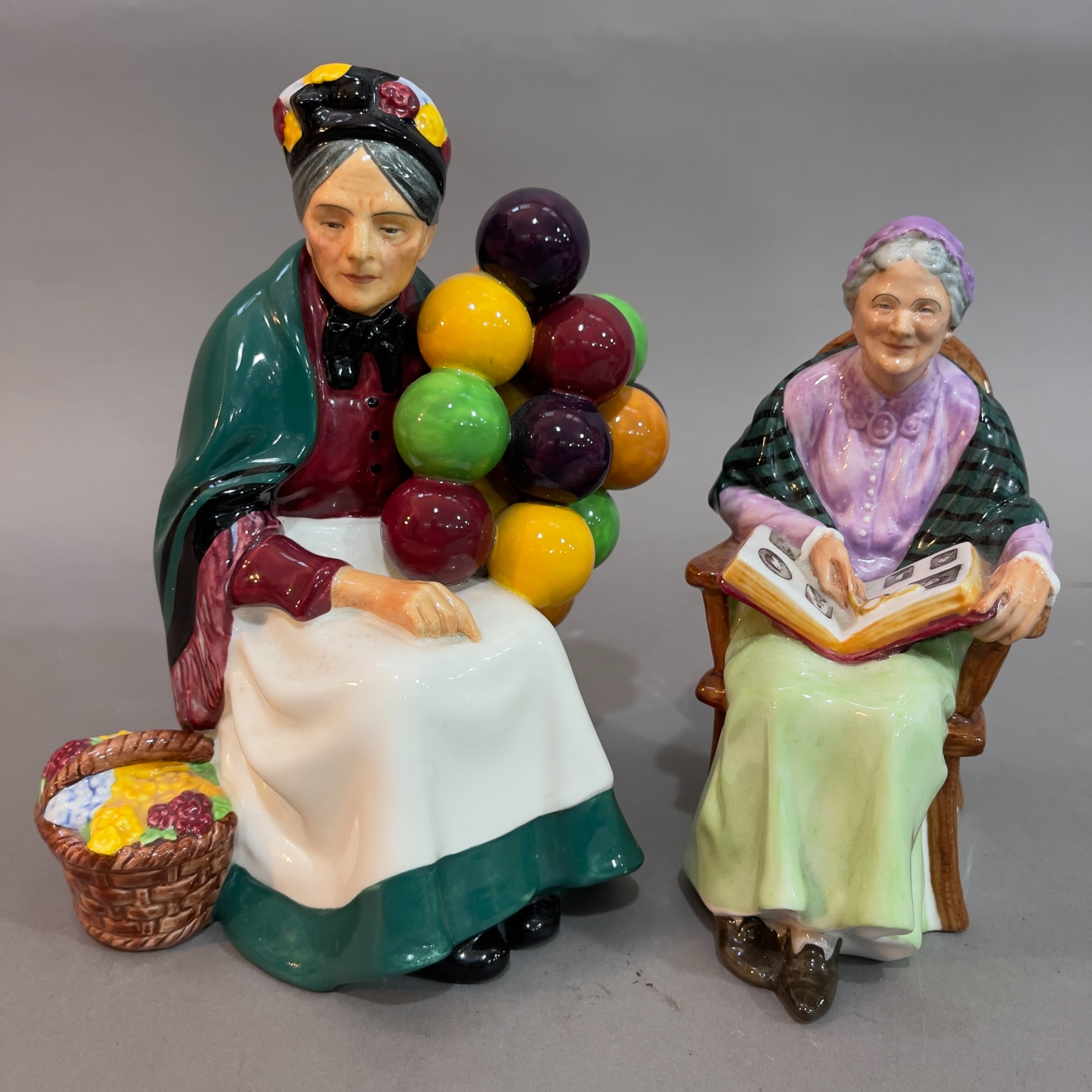 A Royal Doulton ' The Old Balloon Seller' 18cm high and 'The Family Album' figures