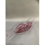 A 1970s studio tinted pink and clear glass dish of elongated form, 63cm wide
