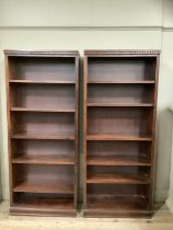 A pair of mahogany open bookcases having carved frieze and six shelves, 76cm wide