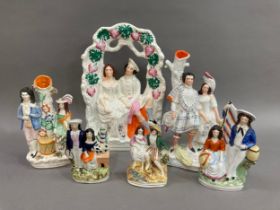 A quantity of 19th century Staffordshire ware including a romantic couple beneath an arbour, Burns