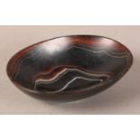 A banded agate bowl of oval outline on foot rim, 9cm wide x 6.5cm deep x 2.75cm high (two cracks