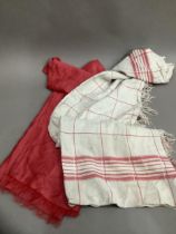 A white and red linen checked table cloth with fringe to opposing ends (hole) together with a